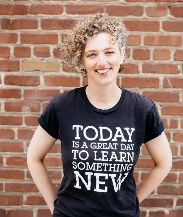 Eva smiling, in a shirt that reads: today is a great day to learn something new.